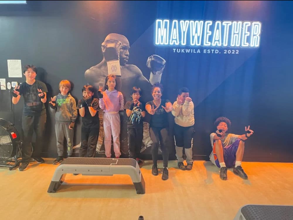 Group of children showing boxing poses at Mayweather Gym in Tukwila, 2022.